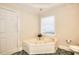 Bright bathroom featuring an elevated bathtub with jets, and ceramic tile flooring at 3889 Pineybrook Dr, Loganville, GA 30052