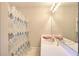 Bathroom with a large mirror, vanity, and a shower with a decorative curtain at 3889 Pineybrook Dr, Loganville, GA 30052