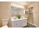 Bright bathroom featuring dual vanity sink, tile flooring, and a shower at 3889 Pineybrook Dr, Loganville, GA 30052