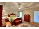 Comfortable bedroom with tray ceiling, warm tones, wood furniture, and light-filled windows at 3889 Pineybrook Dr, Loganville, GA 30052