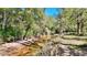 A tranquil creek flows through a densely wooded area, offering a serene natural view at 3889 Pineybrook Dr, Loganville, GA 30052