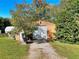 Exterior view of a garage with a driveway and mature trees surrounding the building at 3889 Pineybrook Dr, Loganville, GA 30052