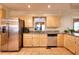 Well-lit kitchen featuring stainless steel appliances and stone countertops at 3889 Pineybrook Dr, Loganville, GA 30052