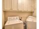 Utility room with modern appliances and plenty of cabinet storage for laundry and cleaning supplies at 3889 Pineybrook Dr, Loganville, GA 30052