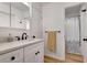 Bathroom with white vanity, black hardware, and a view of a shower with a curtain at 551 Lees Mill Rd, Fayetteville, GA 30214