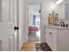 An open door to a bedroom provides a partial view of a bathroom with a white vanity at 551 Lees Mill Rd, Fayetteville, GA 30214
