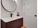 Modern bathroom features a round mirror, custom vanity with a unique finish, and white door at 551 Lees Mill Rd, Fayetteville, GA 30214