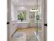 Bright bathroom with a soaking tub, natural light, white cabinets, and a glass-enclosed shower at 551 Lees Mill Rd, Fayetteville, GA 30214