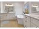 Bright bathroom with double vanities, soaking tub, natural light, and glass-enclosed shower at 551 Lees Mill Rd, Fayetteville, GA 30214