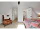 Bedroom with a tropical themed bed, accent chair, and a view of multiple doors at 551 Lees Mill Rd, Fayetteville, GA 30214