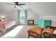 Bedroom with a fan, a bed with a floral comforter, and a teal dresser and curtains at 551 Lees Mill Rd, Fayetteville, GA 30214