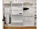 A modern closet with white shelving, hanging rods, and hardwood flooring at 551 Lees Mill Rd, Fayetteville, GA 30214
