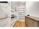 Organized walk-in closet featuring white shelves, hanging rods, and a dresser at 551 Lees Mill Rd, Fayetteville, GA 30214