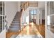 Grand foyer showcasing hardwood floors, staircase, and natural light at 551 Lees Mill Rd, Fayetteville, GA 30214