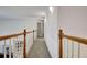 Light and bright hallway with wood railing and carpet flooring at 551 Lees Mill Rd, Fayetteville, GA 30214