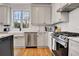 Beautiful kitchen featuring a farmhouse sink, stainless steel appliances, and white subway tile backsplash at 551 Lees Mill Rd, Fayetteville, GA 30214