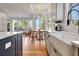 Bright open concept kitchen featuring white cabinets, a farmhouse sink, and an adjacent dining area at 551 Lees Mill Rd, Fayetteville, GA 30214