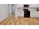 A kitchen featuring modern white cabinets, stainless steel appliances, and hardwood flooring at 551 Lees Mill Rd, Fayetteville, GA 30214