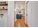 View of the kitchen featuring hardwood floors, recessed lighting, a blue island, and white cabinetry at 551 Lees Mill Rd, Fayetteville, GA 30214