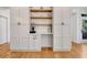 Kitchen featuring custom cabinetry, a built-in desk, and open shelving with modern decor at 551 Lees Mill Rd, Fayetteville, GA 30214