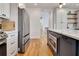 Spacious kitchen featuring stainless steel appliances, white cabinetry, and a dark blue island at 551 Lees Mill Rd, Fayetteville, GA 30214