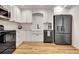A kitchen featuring modern white cabinets, stainless steel appliances, and hardwood flooring at 551 Lees Mill Rd, Fayetteville, GA 30214