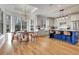 A bright kitchen and dining area with white cabinets, a blue island, and a view of the surrounding trees at 551 Lees Mill Rd, Fayetteville, GA 30214