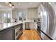Well-equipped kitchen boasts stainless steel appliances, white cabinets, and a dark blue island at 551 Lees Mill Rd, Fayetteville, GA 30214