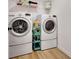 The laundry room features a white washer and dryer with a cart with cleaning supplies at 551 Lees Mill Rd, Fayetteville, GA 30214