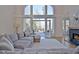 Bright living room with high ceilings, a fireplace, comfortable furniture, and access to an outdoor balcony at 551 Lees Mill Rd, Fayetteville, GA 30214