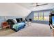 Living room with blue walls and a sectional sofa, a large window with a view at 551 Lees Mill Rd, Fayetteville, GA 30214