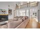 Open-concept living room with a fireplace, shelving, and natural light at 551 Lees Mill Rd, Fayetteville, GA 30214