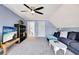 Comfortable living room features plush carpeting and a soft blue paint palette at 551 Lees Mill Rd, Fayetteville, GA 30214
