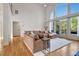 Bright living room features large windows, hardwood floors and a comfortable sectional sofa at 551 Lees Mill Rd, Fayetteville, GA 30214