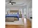 Comfortable main bedroom with a king bed, lots of natural light, and hardwood floors at 551 Lees Mill Rd, Fayetteville, GA 30214