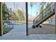 Outdoor pool area with lounge chairs, staircase, and lush greenery at 551 Lees Mill Rd, Fayetteville, GA 30214