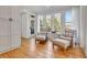 Cozy sitting area with plush chairs and ottomans, complemented by natural light from large windows and a view of nature at 551 Lees Mill Rd, Fayetteville, GA 30214