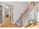 Carpeted staircase with wooden banister and an open view of the entryway at 551 Lees Mill Rd, Fayetteville, GA 30214
