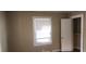 This bedroom features a window with blinds, closet space, and neutral-toned walls at 1497 Clermont Ct, Atlanta, GA 30344