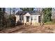 Charming single story home with a welcoming entrance, framed by mature landscaping and a cozy porch at 1497 Clermont Ct, Atlanta, GA 30344