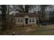 A single-story house with a tidy front yard, featuring a classic facade and natural surroundings at 1497 Clermont Ct, Atlanta, GA 30344