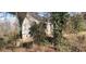 The side exterior of a house with trees and growth nearby at 1497 Clermont Ct, Atlanta, GA 30344