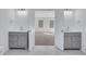 Bathroom featuring double sinks, tile flooring, and view into the main bedroom at 2250 Deer Oaks Trl, Lawrenceville, GA 30044