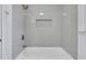 Bright, newly-renovated bathroom featuring tiled walls and a modern shower/tub combo at 2250 Deer Oaks Trl, Lawrenceville, GA 30044