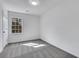 Bedroom featuring neutral carpet and white walls with a view of outdoors through a window at 2250 Deer Oaks Trl, Lawrenceville, GA 30044