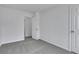 Bedroom with neutral carpet and white walls, two doors and large window at 2250 Deer Oaks Trl, Lawrenceville, GA 30044