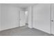Bedroom with neutral walls and carpet; a door leads to another room at 2250 Deer Oaks Trl, Lawrenceville, GA 30044