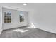 Bright bedroom featuring neutral walls, carpet, and two windows letting in natural light at 2250 Deer Oaks Trl, Lawrenceville, GA 30044
