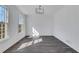 Bright dining room featuring a modern light fixture, fresh white paint, and gray wood flooring at 2250 Deer Oaks Trl, Lawrenceville, GA 30044