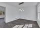 Bright dining room featuring a modern light fixture, fresh white paint, and gray wood flooring at 2250 Deer Oaks Trl, Lawrenceville, GA 30044